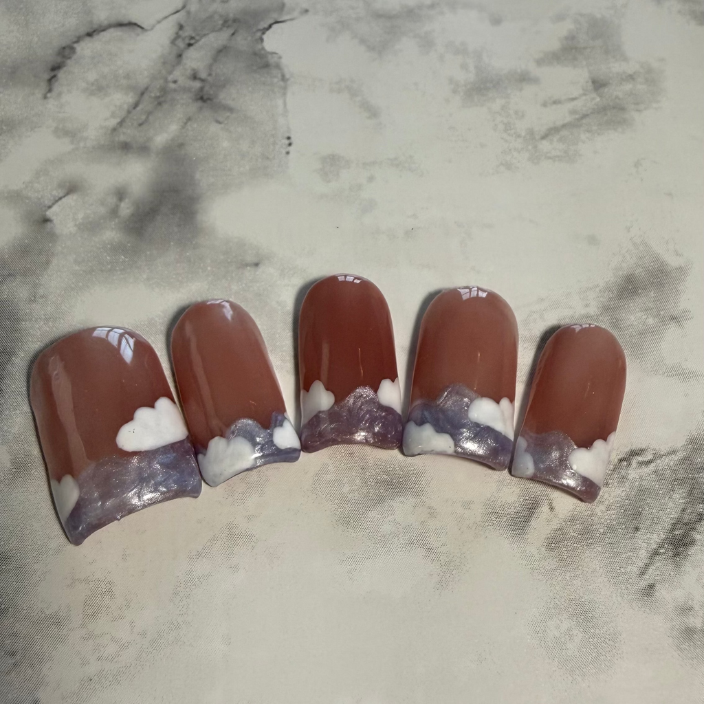 Pink base nails with a purple swirly French tip and white clouds on top