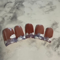 Pink base nails with a purple swirly French tip and white clouds on top
