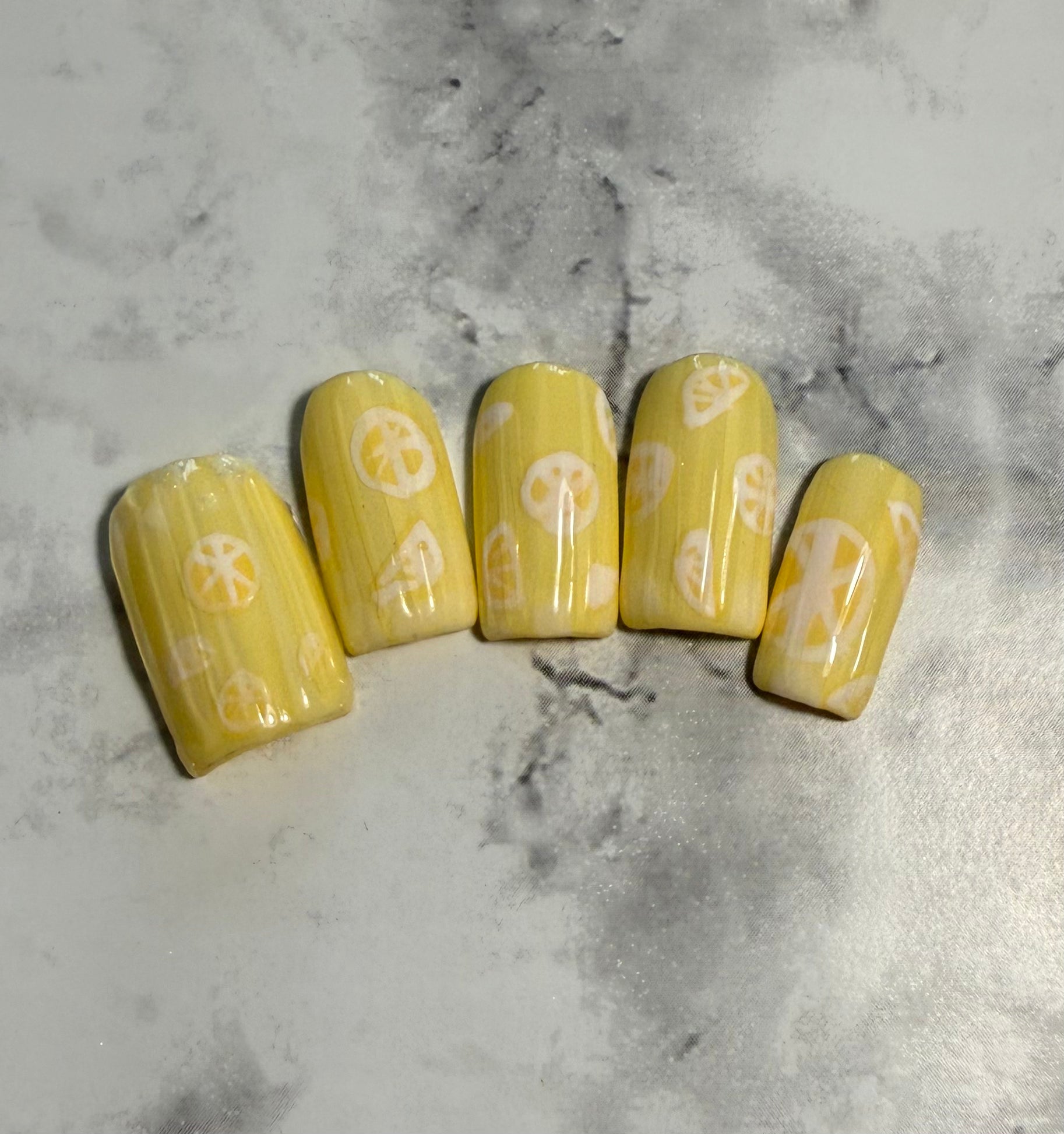 Yellow nail art designs with lemon slices with a ribbed glass effect on top