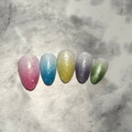 Five glittery almond shaped nails that are pink, blue, yellow, purple, and green made to look like snow cones 
